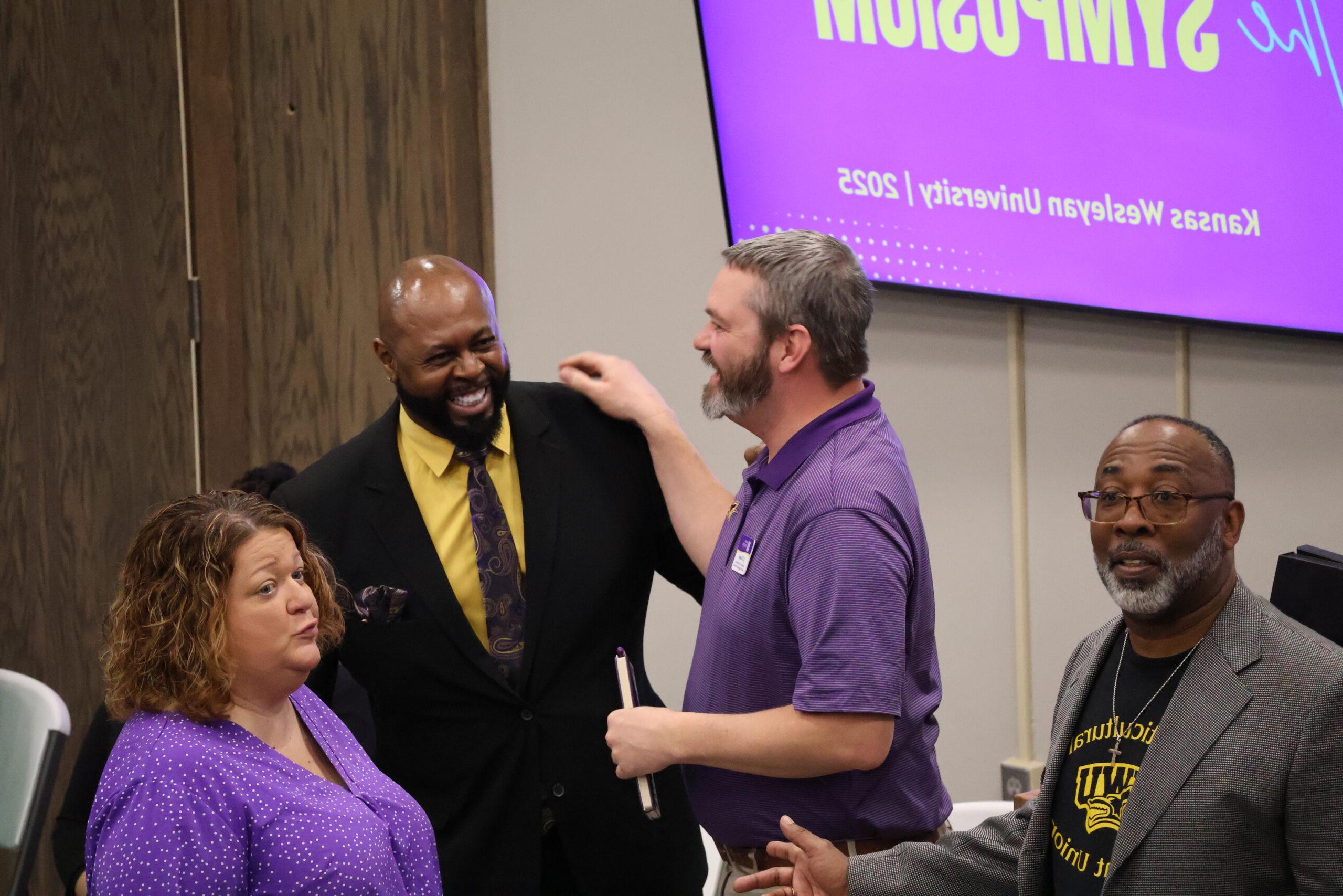 Man with hand on shoulder and people laughing